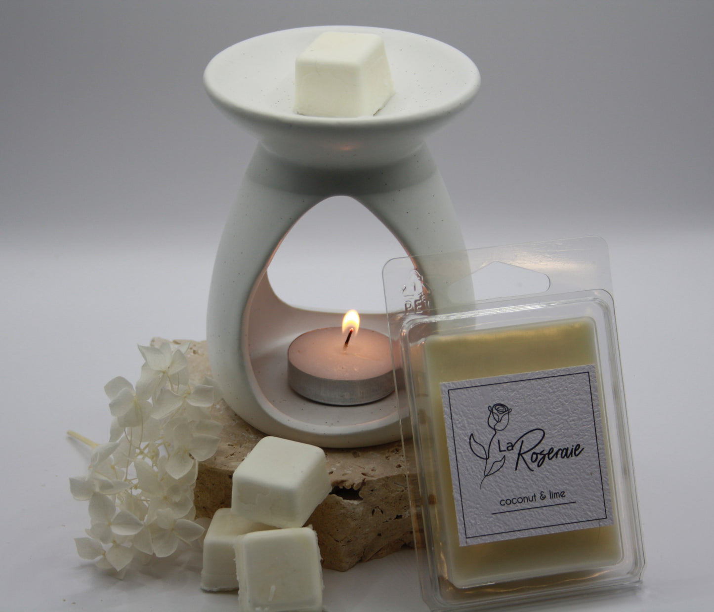 La Roseraie coconut 6 pack soy wax melts. Coconut Lime fragrance, with wax melter alight.